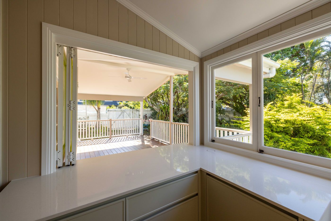 Queenslander verandah seen through a kitchen servery window in Balmoral