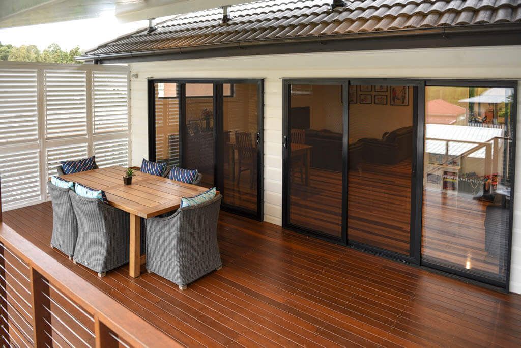 Elevated timber deck with dining area in Holland Park