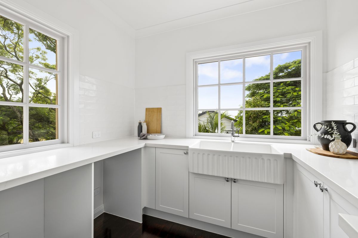Renovated laundry with white cabinetry