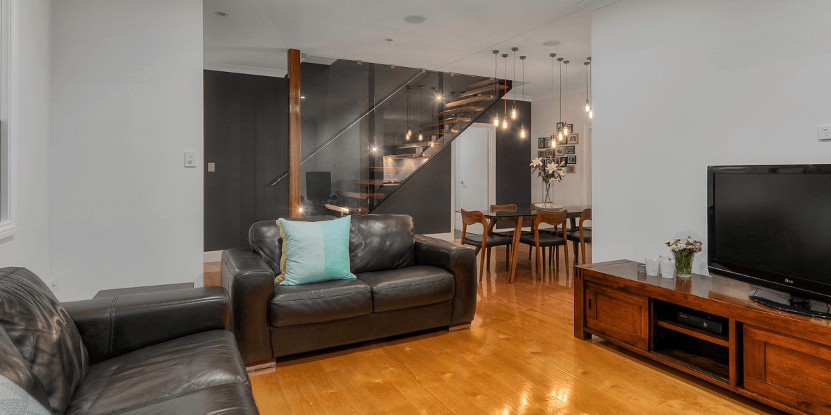 Living and dining area with the new staircase in a lifted Greenslopes home