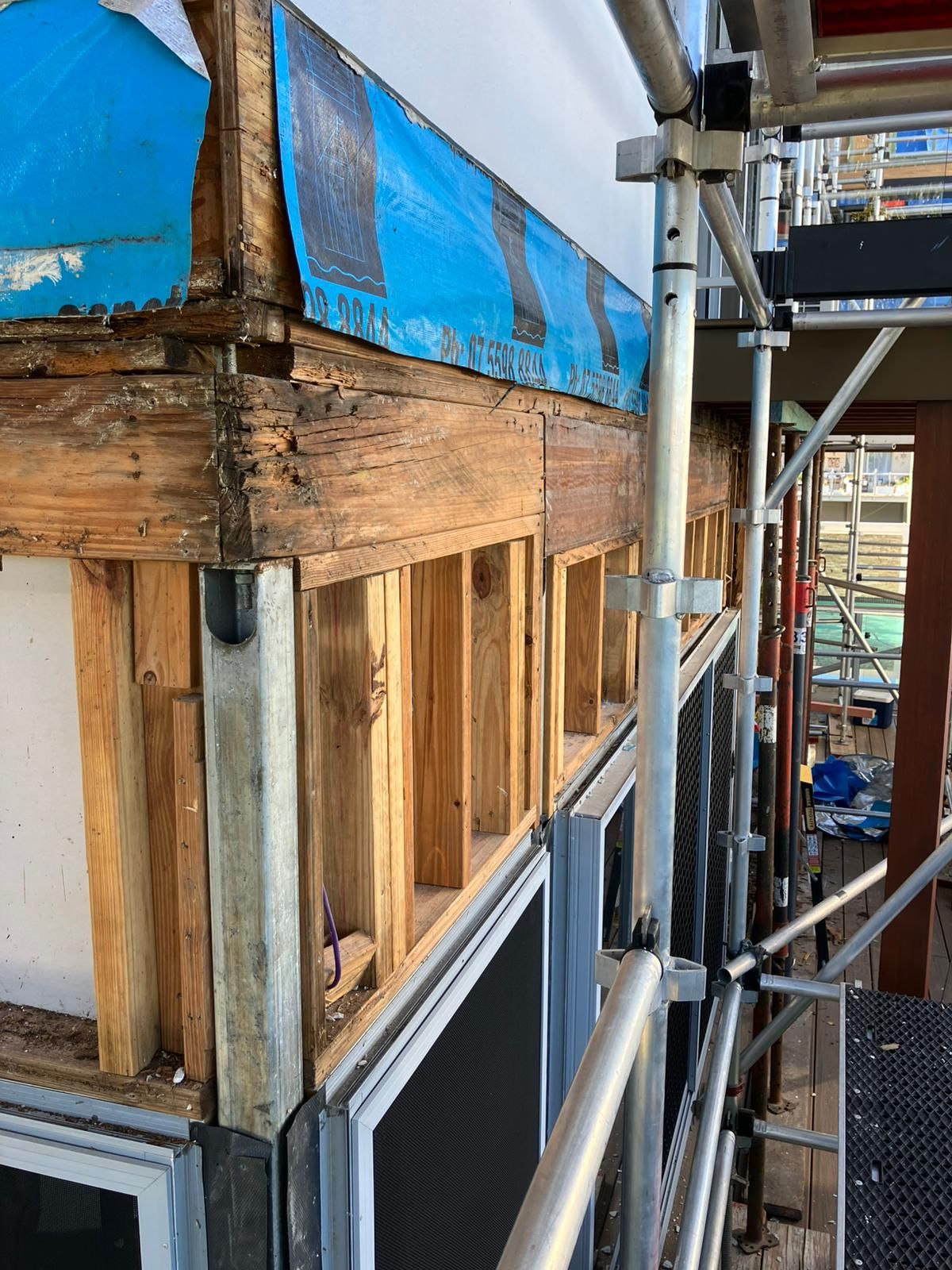 Wall framing with a steel post during a structural repair
