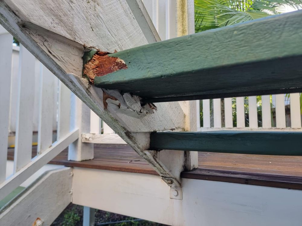 Rotten stair stringer where it meets the handrail