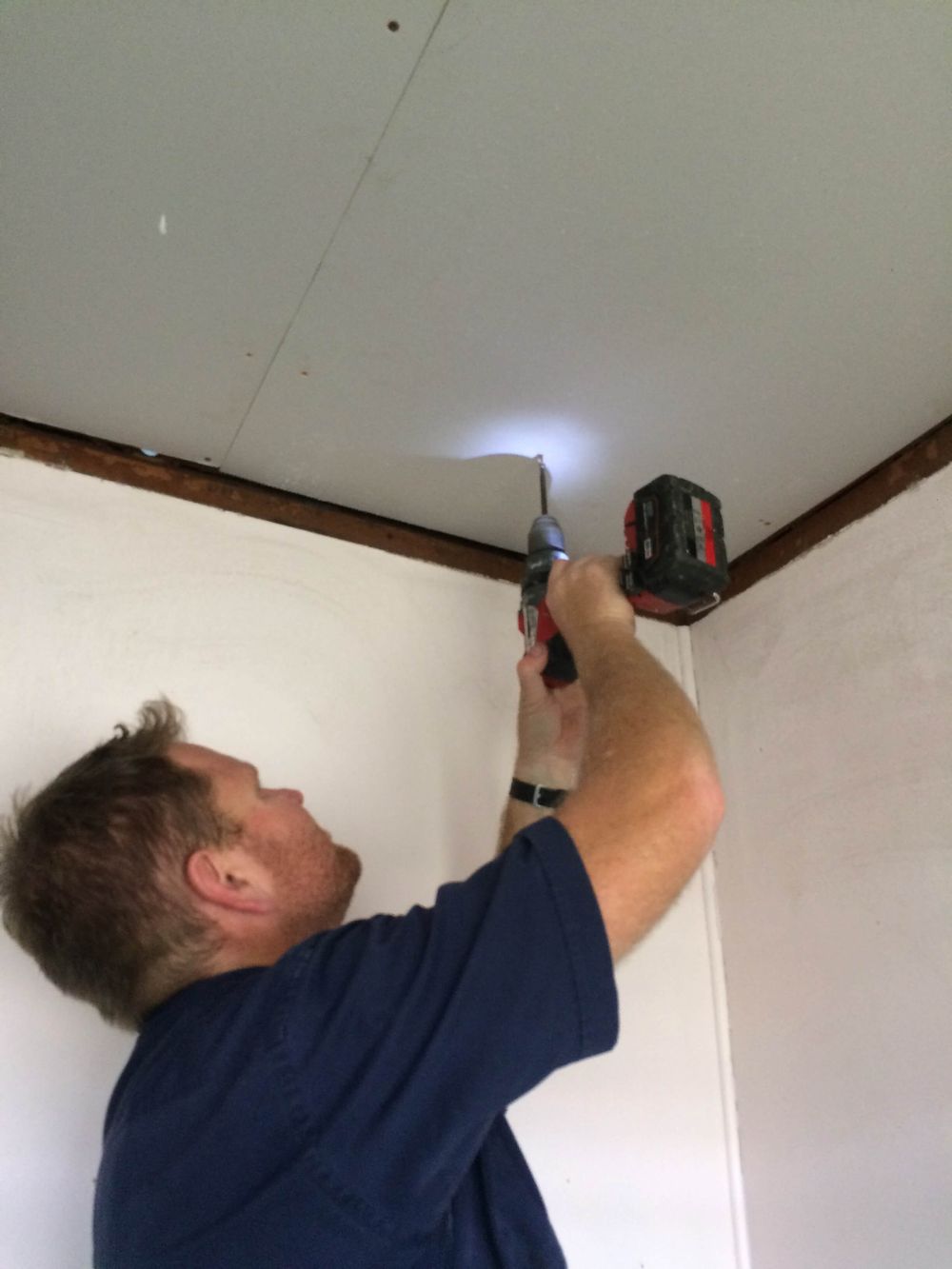 Fixing new plasterboard to the repaired ceiling framing